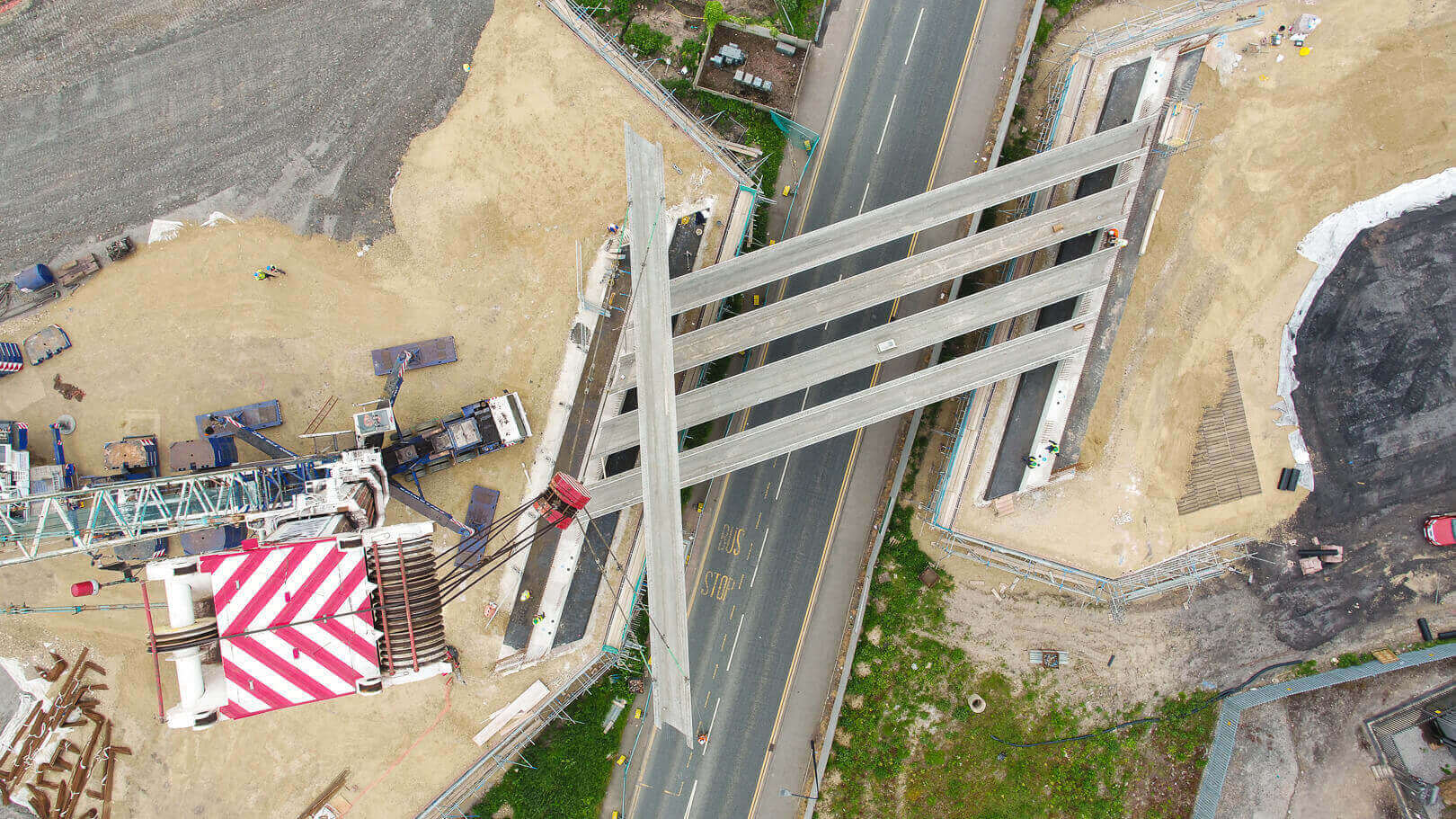 Aerial drone photography - Crane carrying bridge beams at the new A49 Link Road, Wigan for Jones Bros