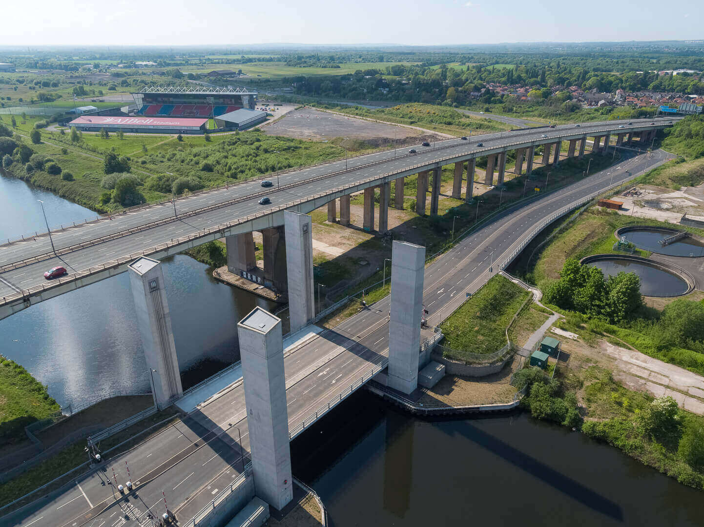 Aerial drone photography of the A57 lift bridge adjacent to the M60 motorway running over the Manchester Ship Canal, Manchester