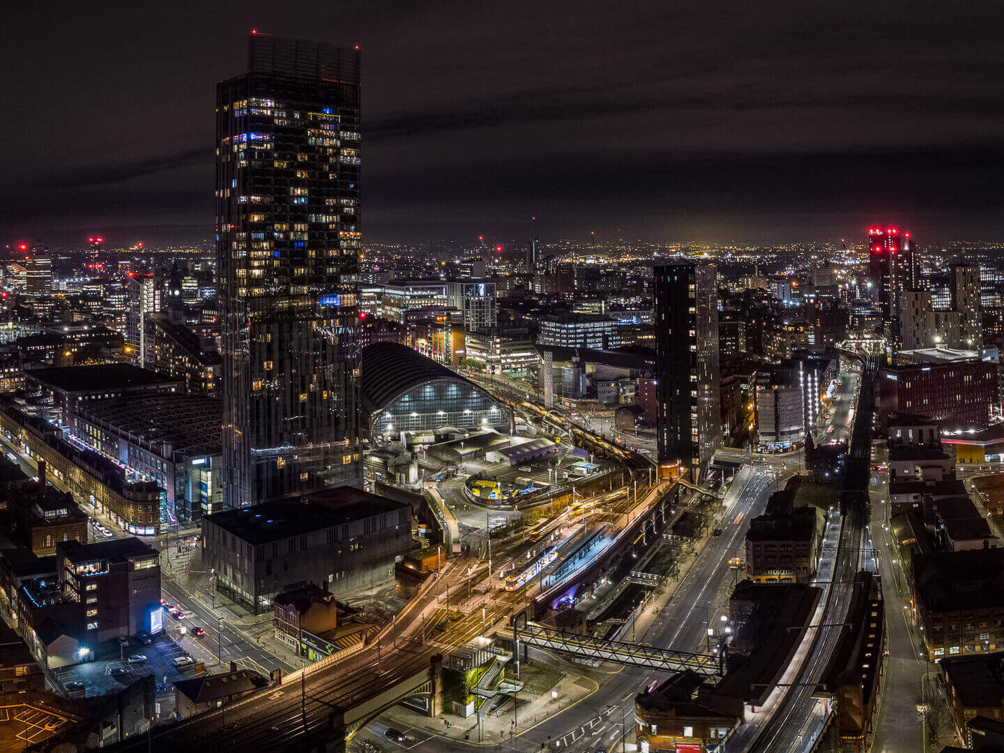 Aerial drone photography of Manchester at night including Beetham Tower, Manchester Central AXIS and First Street