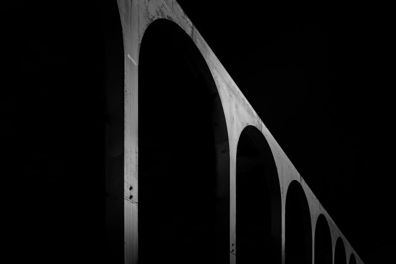 Black and white fine art image of a metal footbridge in Civitavecchia, Rome, Italy