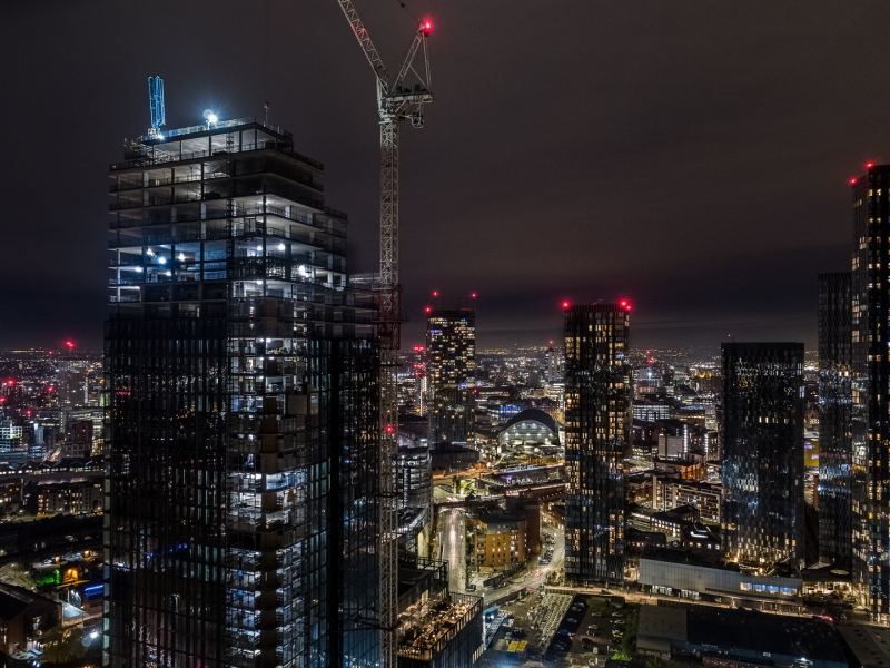 Drone photography of Manchester City centre at night including the Elizabeth Tower construction, Deansgate Square & Beetham Tower